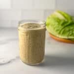 A jar of vegan Caesar dressing.
