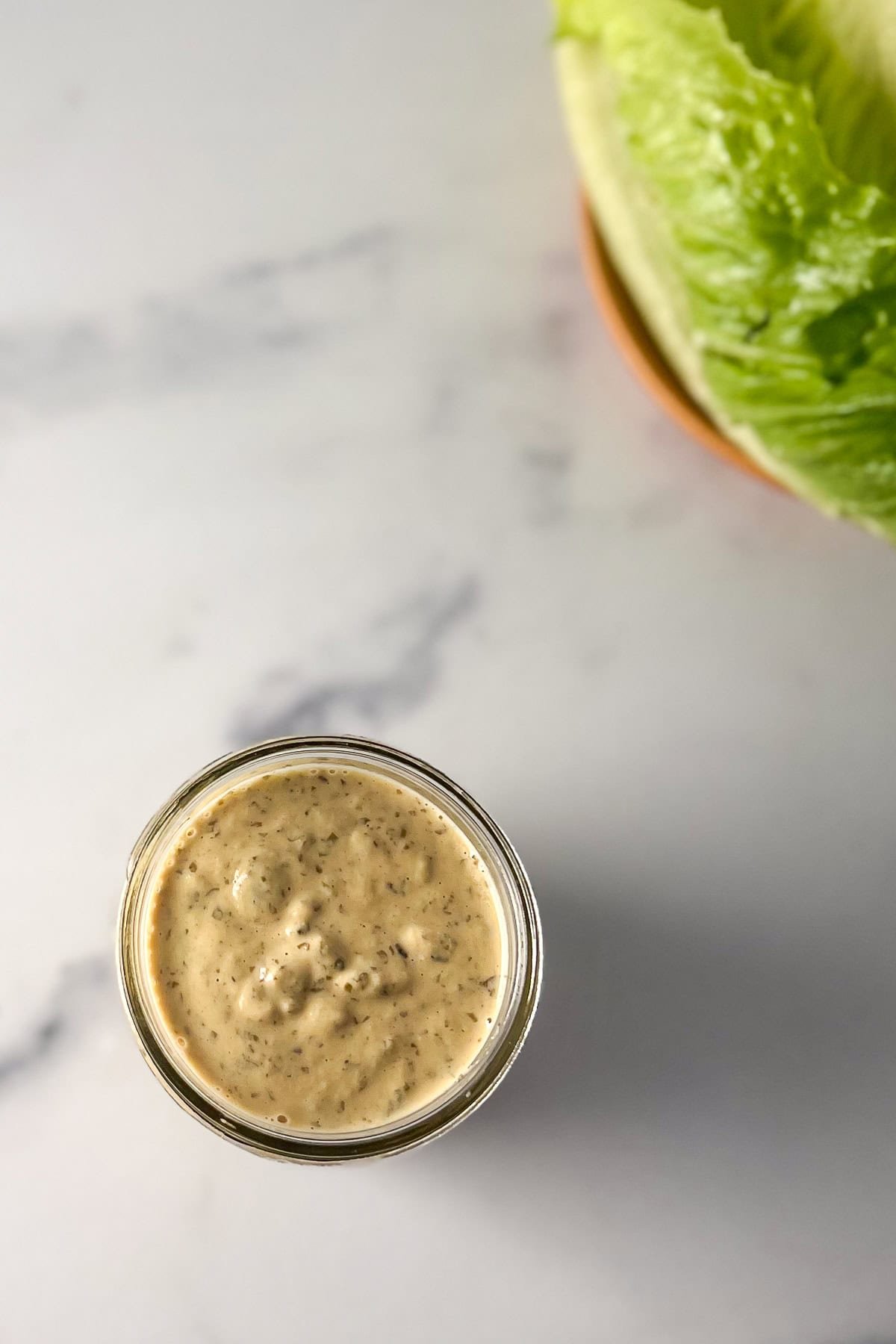 A jar of vegan Caesar dressing.