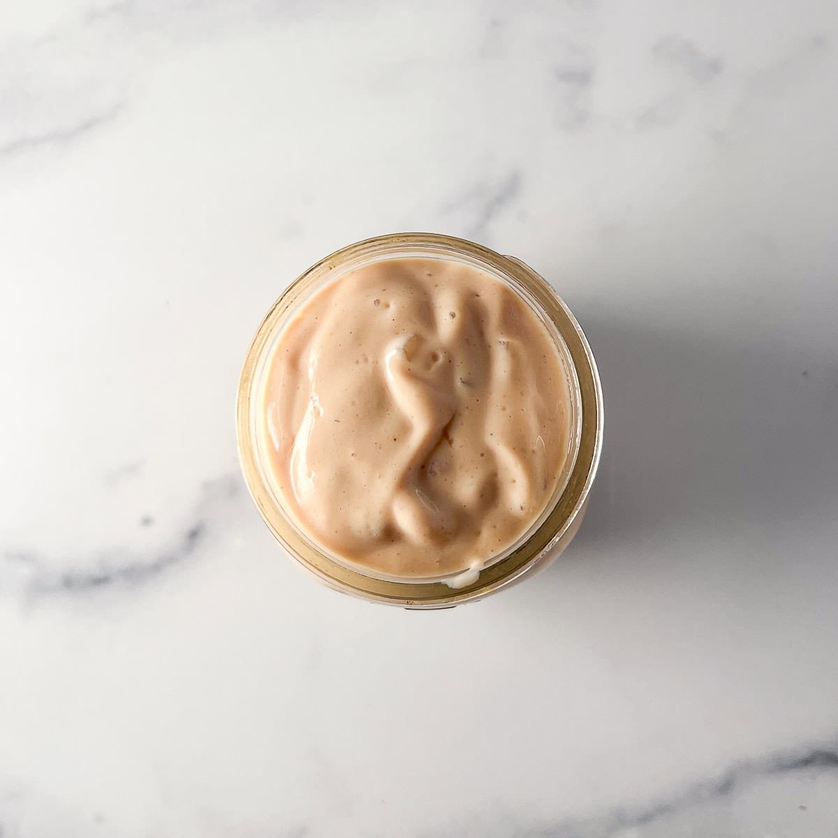 A jar of vegan thousands island dressing.