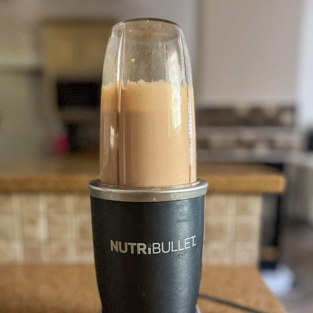 A small blender with vegan thousand island dressing.