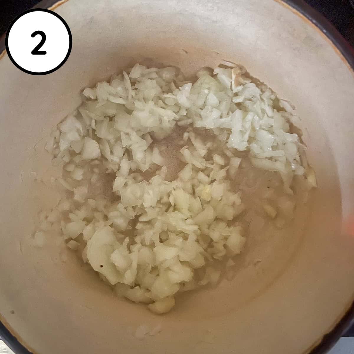 Chopped onions sautéing in a pot.