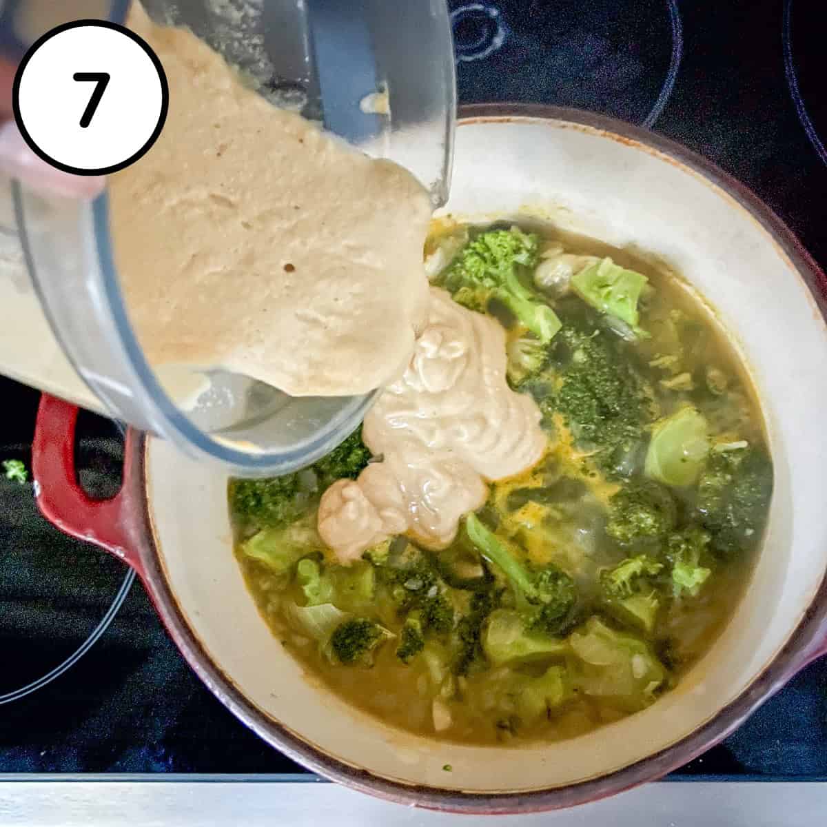 Blended cashew cream base being added to the pot with broccoli and vegetable broth.