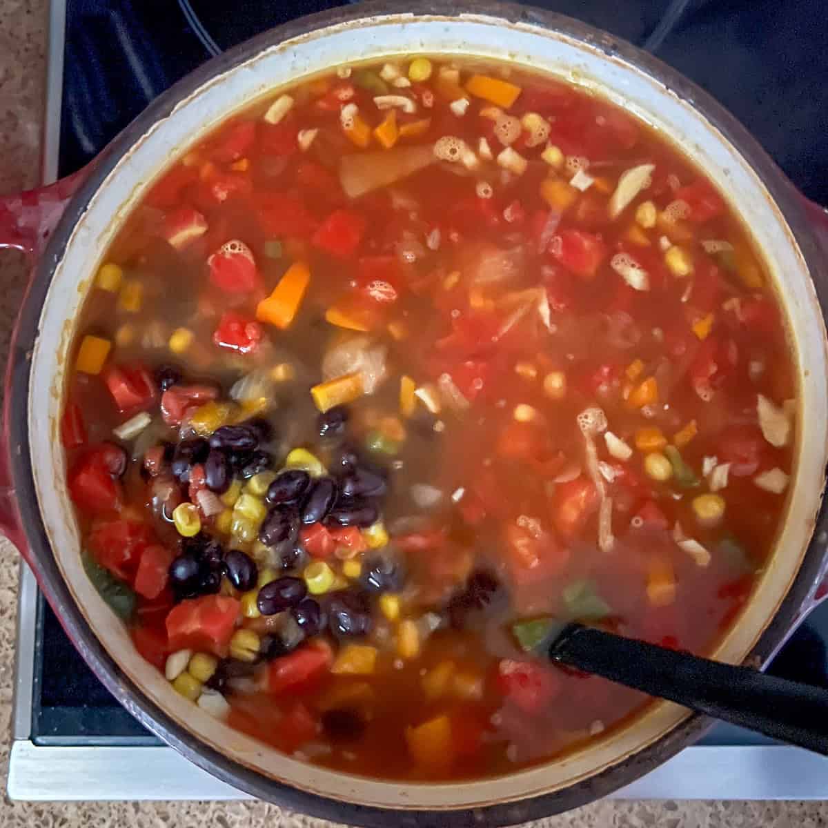 Black beans added to the pot with other ingredients.