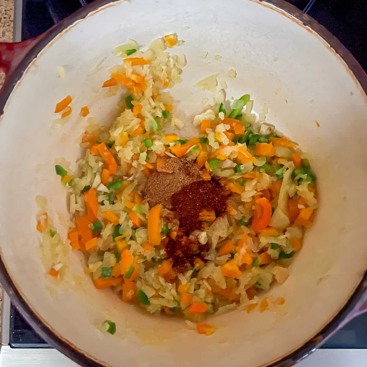 Spices added to the pot with sauteed veggies.