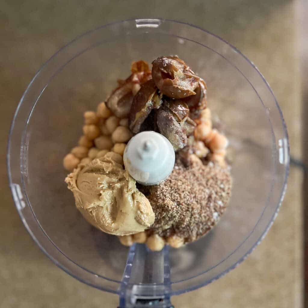 Vegan cookie dough ingredients in a food processor before processing.