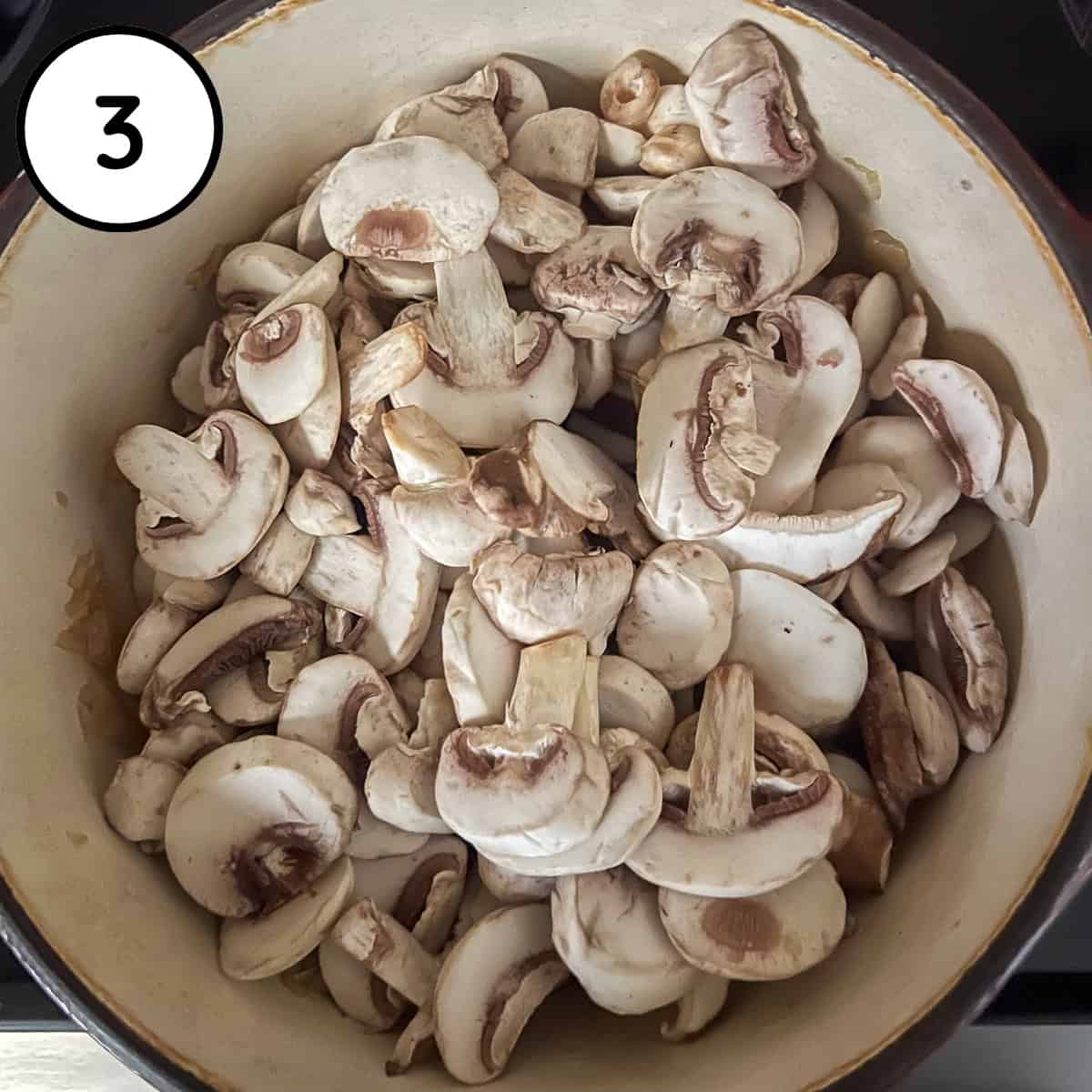 Mushrooms added to the pot on the stovetop.