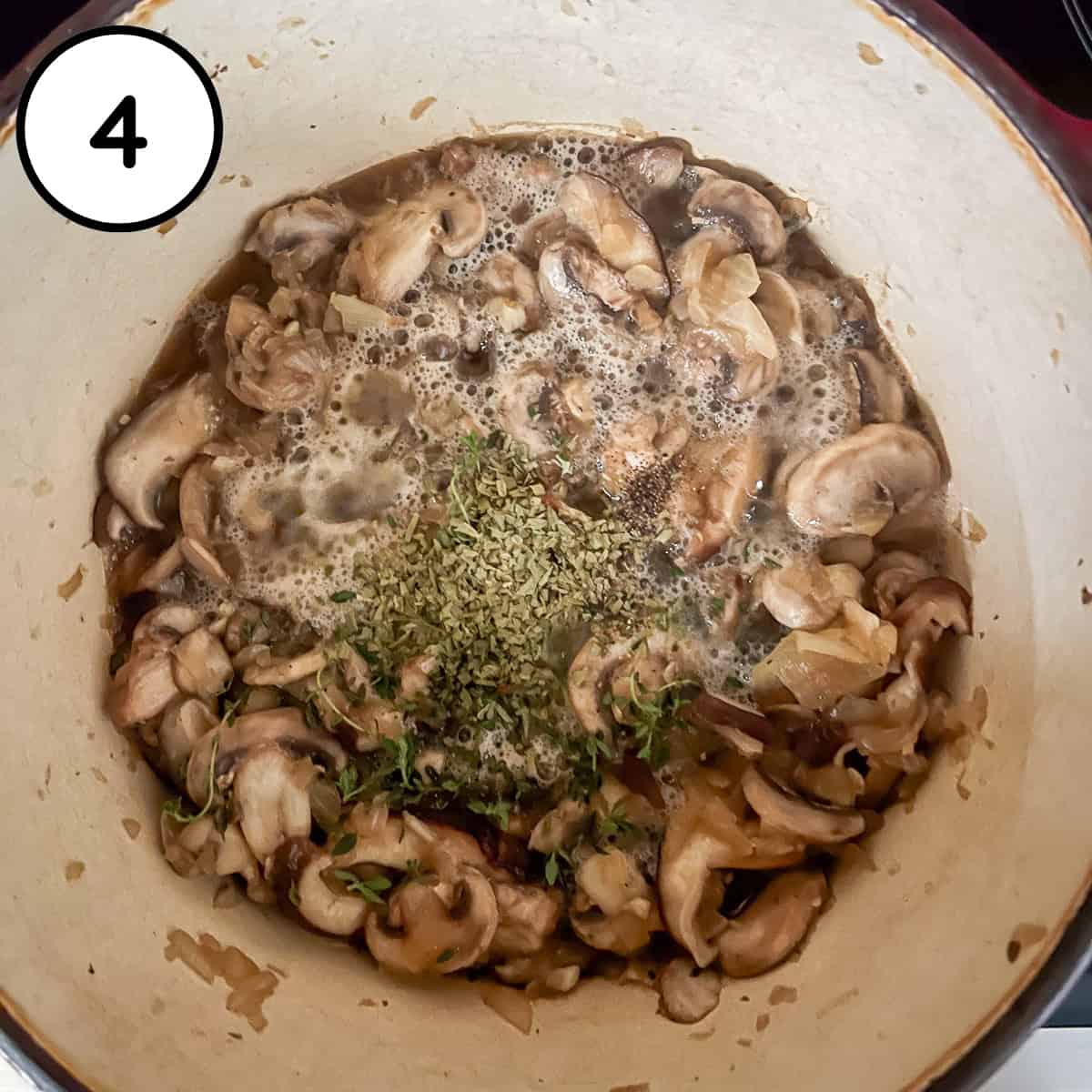 Cooked mushrooms, onions, garlic, broth and herbs in the pot.