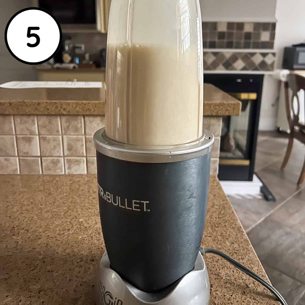 Cream sauce being processed in a bullet blender.