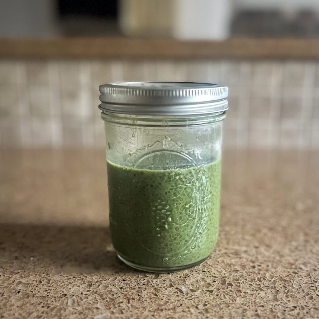 Matcha chia pudding in a mason jar with a lid to go into the refrigerator to set.
