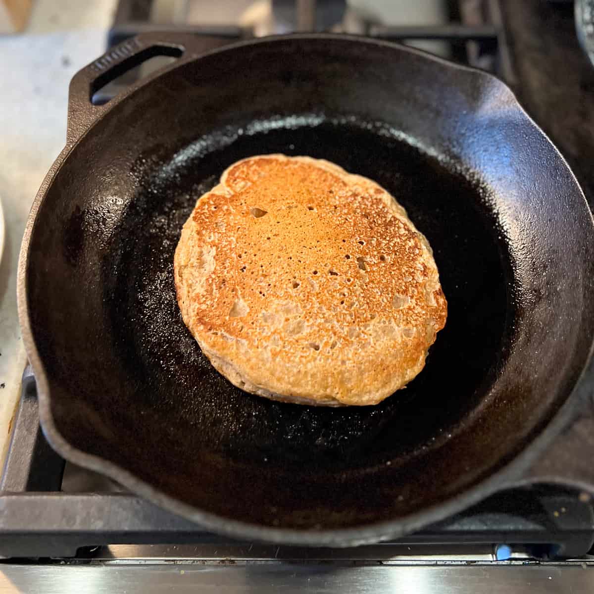 Pancake cooking in the skillet.