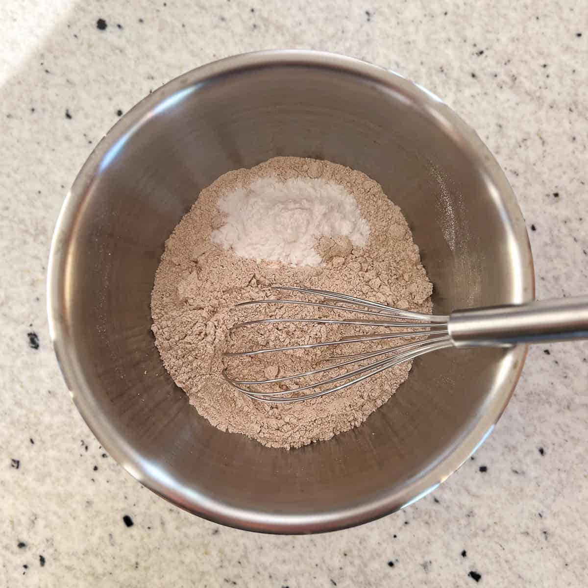 Other dry ingredients in a mixing bowl with a whisk to combine.