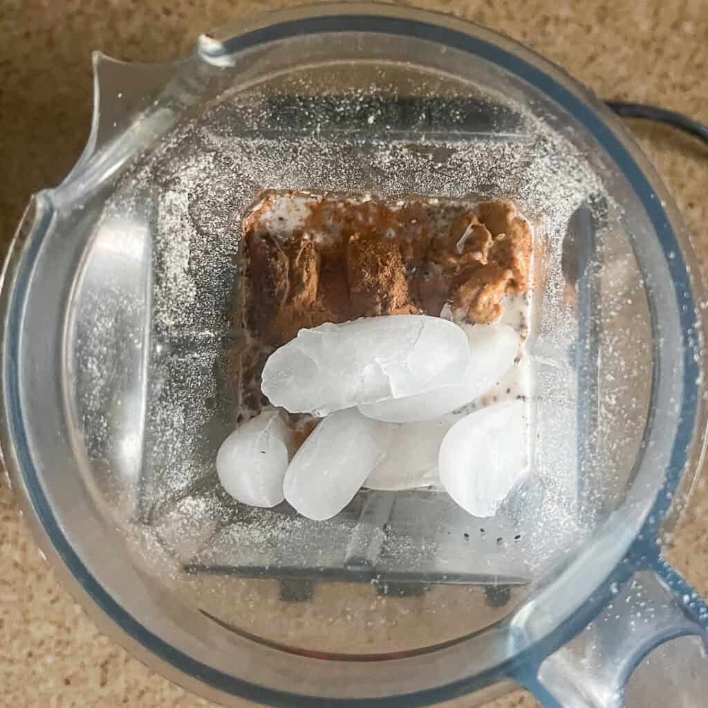 Smoothie ingredients in a blender pitcher before blending.