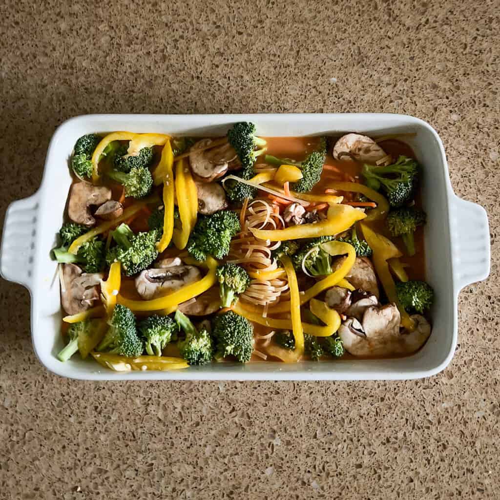 Mushrooms and veggies added to the casserole dish.