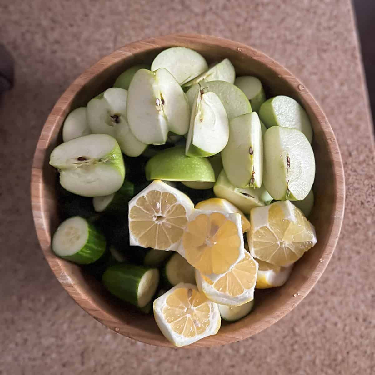 Washed, chopped and trimmed celery, cucumbers, green apples, and lemons.