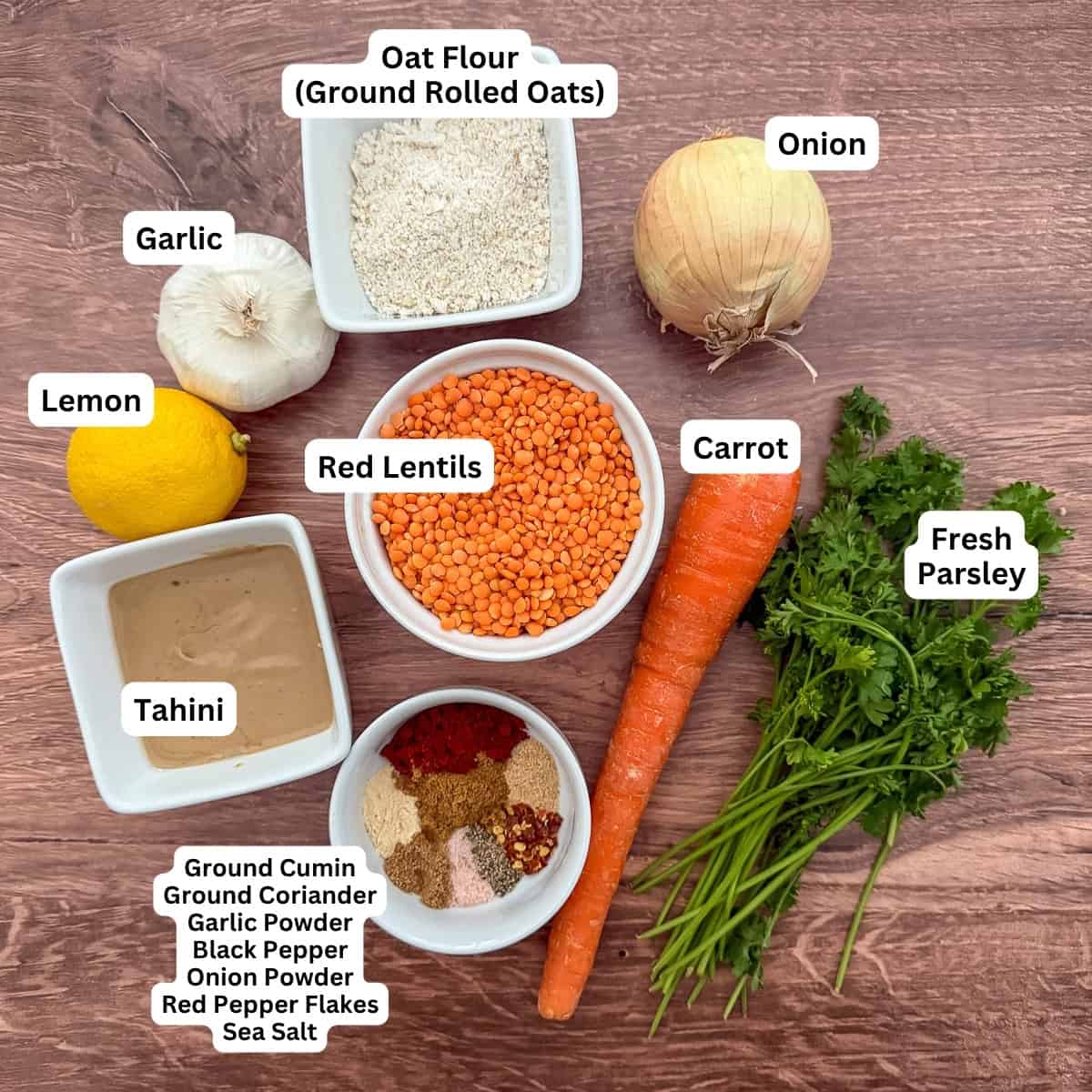 Ingredients for red lentil fritters: oat flour, onion, carrot, fresh parsley, red lentils, garlic, lemon, tahini, and spices.