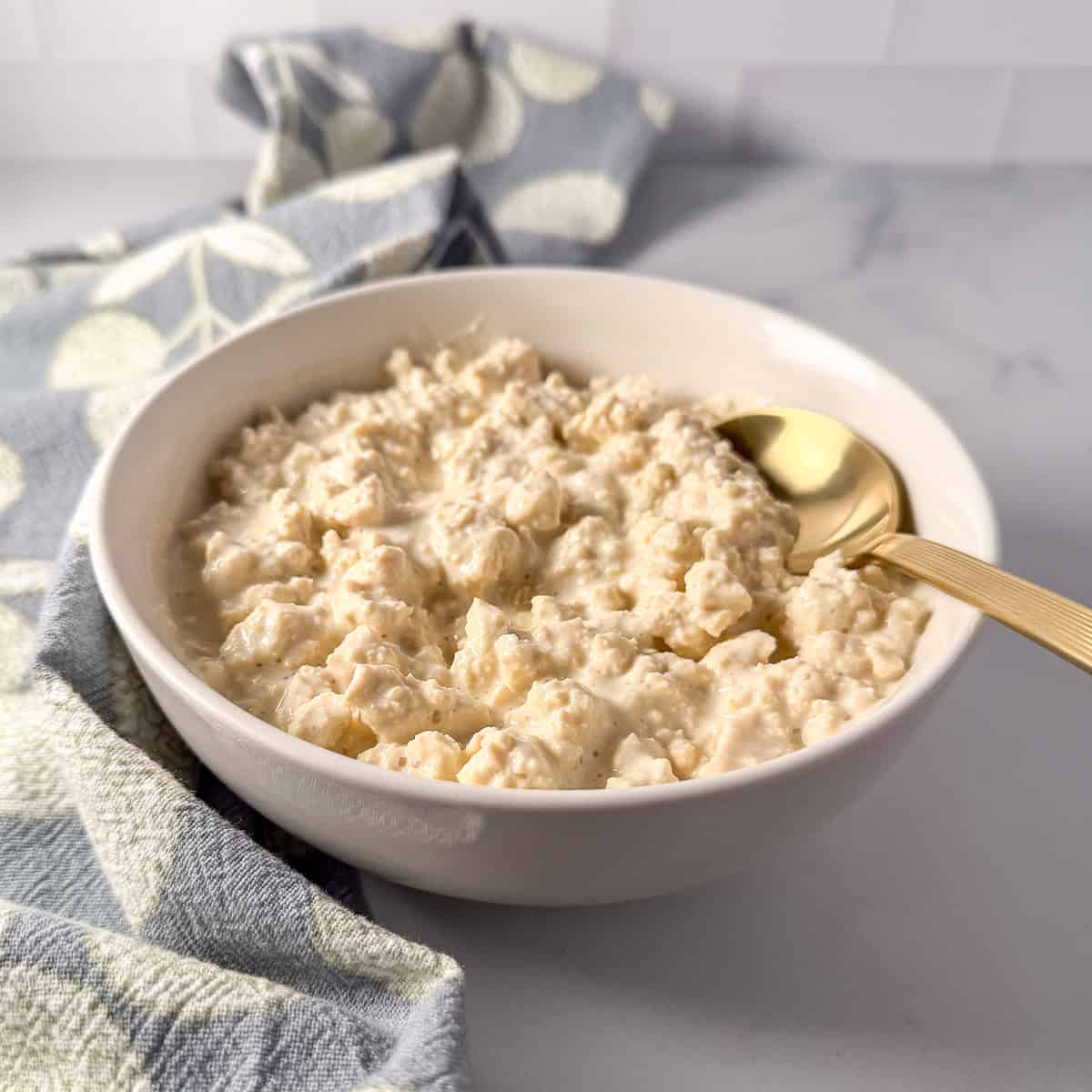 Vegan cottage cheese in a bowl with a spoon.
