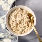 A bowl of vegan cottage cheese with a spoon.