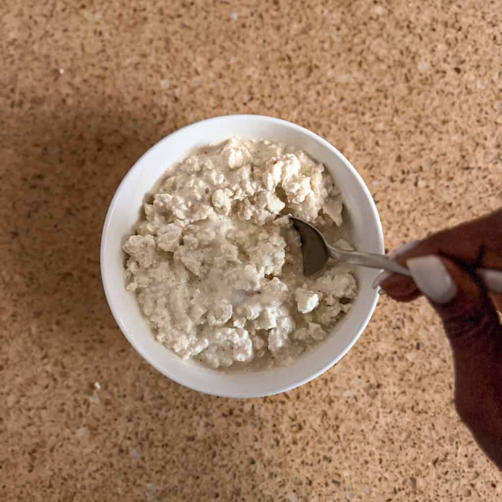 The cottage cheese mixture being stirred with a spoon.