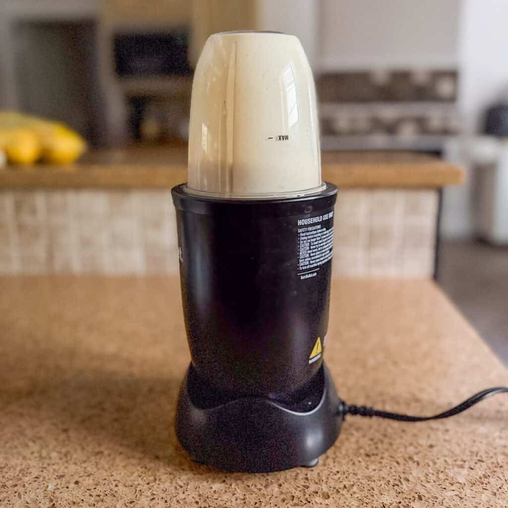 Tzatziki sauce being blended in a bullet blender.