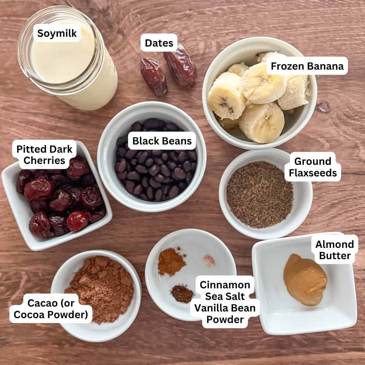 Ingredients for chocolate black bean smoothie: soy milk, dates, frozen banana, black beans, dark pitted cherries, ground flaxseeds, almond butter, cocoa powder, cinnamon, sea salt and vanilla bean powder.