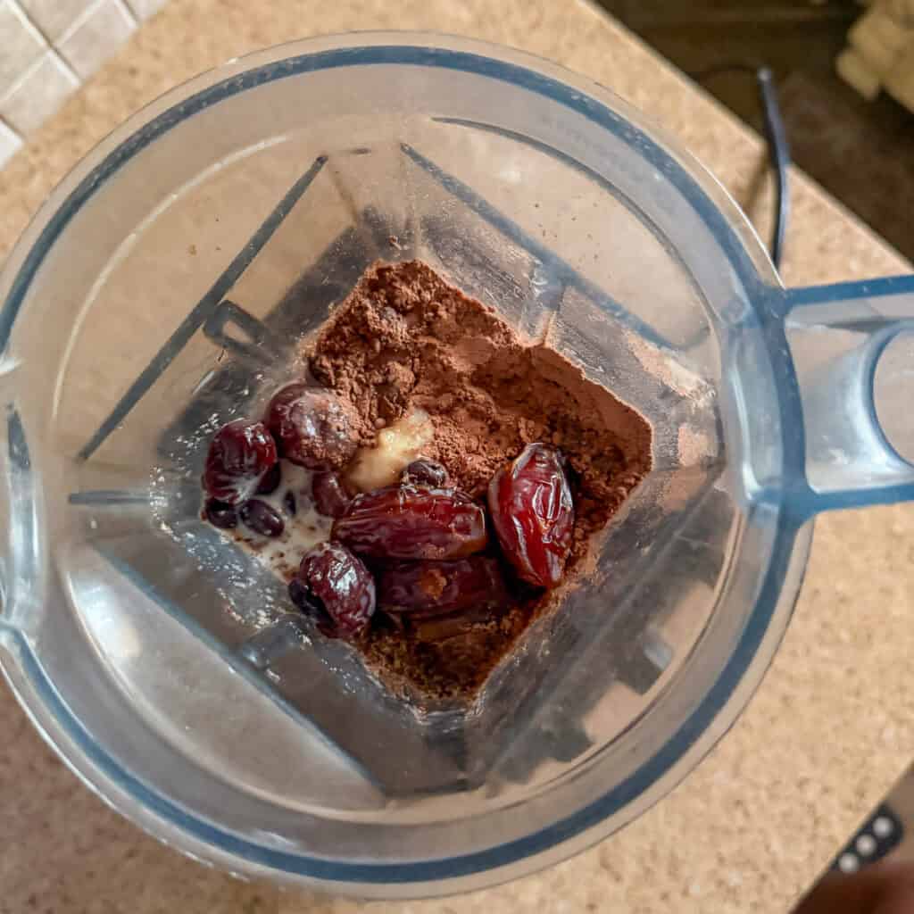 Chocolate black bean smoothie ingredients in a high speed blender pitcher before blending.