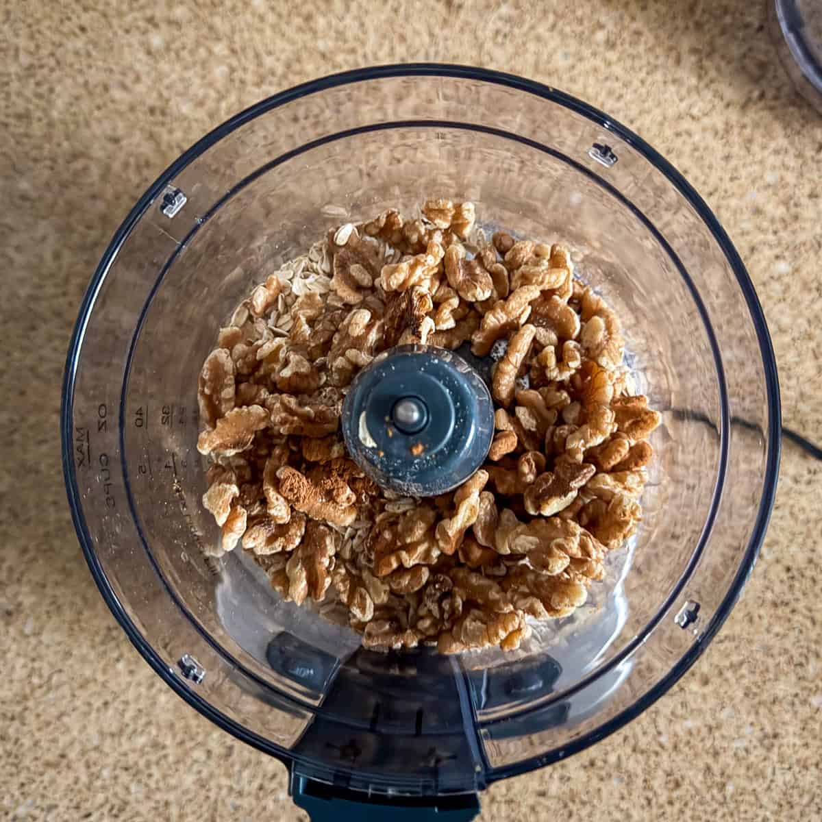 Ingredients for the crust in a food processor bowl.