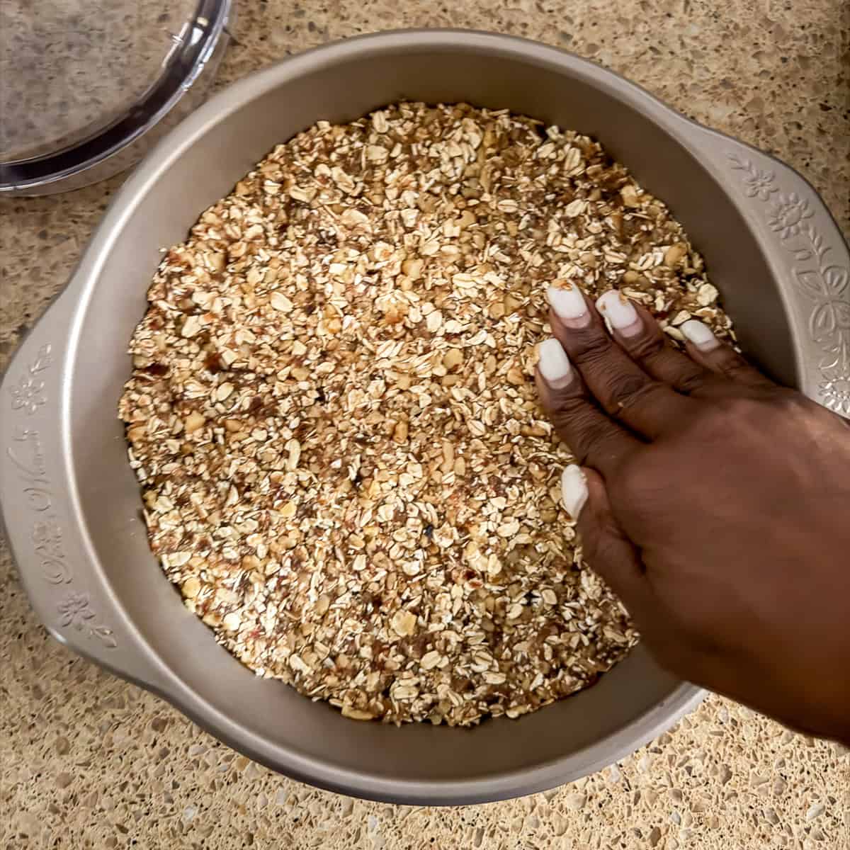 Pie crust being pressed into the pan.