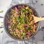 Vegan egg roll in a bowl with a wooden spoon.