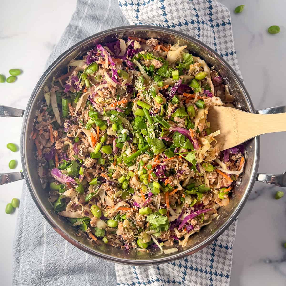 Vegan egg roll in a bowl with a wooden spoon.
