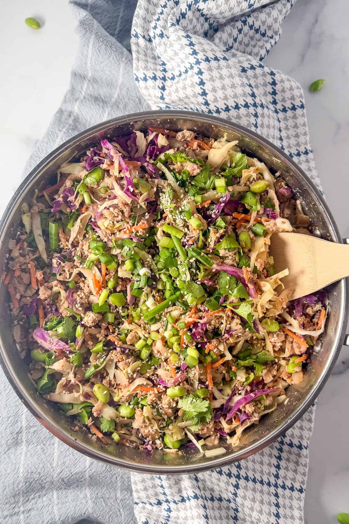 vegan egg roll in a bowl with a wooden spoon.